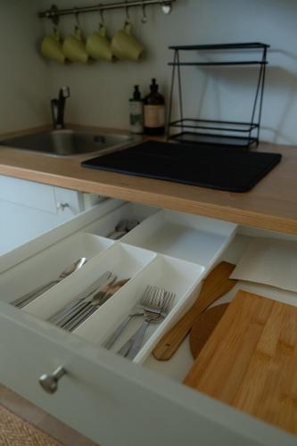 a drawer in a kitchen with utensils at Nidos SKALVA in Neringa
