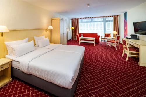 a hotel room with a large bed and a desk at Hotel Chateau Berlin Kurfürstendamm in Berlin