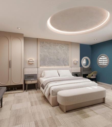 a bedroom with a large bed and blue walls at Pine Beach Belek in Belek