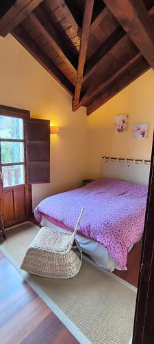 a bedroom with a bed with a basket on the floor at La Casuca de Pechón in Pechón