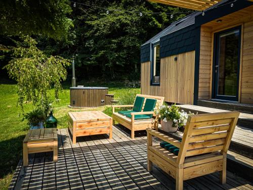 a patio with two chairs and a table and benches at Posestvo Brida in Ilirska Bistrica