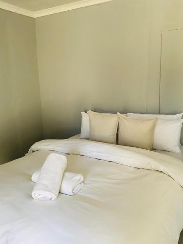 two beds in a room with towels on them at Koshoka Home in Ompanda