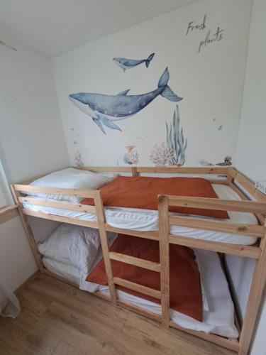 a bunk bed with a dolphin mural on the wall at Ferienhaus am Edersee-scheid in Waldeck