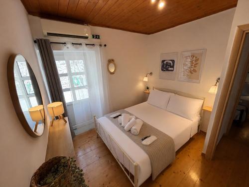 a bedroom with a bed with two towels on it at Salt & Stone in Drymon