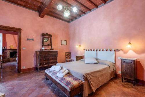a bedroom with a bed and a dresser and a mirror at Tenuta Bichi Borghesi in Monteriggioni