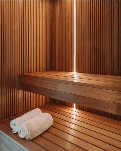 a sauna with a towel laying on a wooden floor at Palmera in Władysławowo