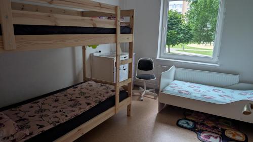 a bedroom with two bunk beds and a window at Celtnieku 8 in Ventspils