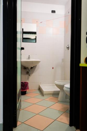 a bathroom with a sink and a toilet at Valsesia Hostel in Scopello