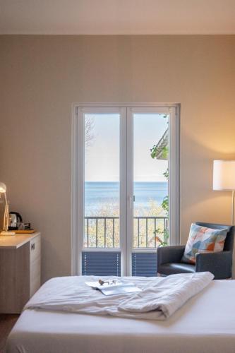 a bedroom with a bed and a view of the ocean at Hotel Alte Fischereischule in Eckernförde