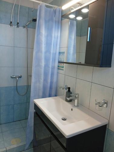 a bathroom with a white sink and a shower at Kalivakia View in Tsoukalades
