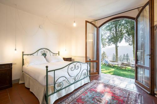 a bedroom with a bed and an open door at Agriturismo Poggio Nardini in Montelupo Fiorentino