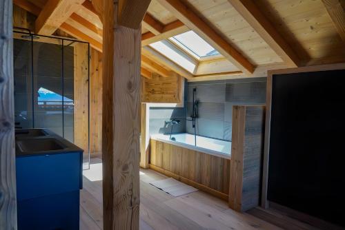 a bathroom with a tub and a sink and a window at Splendide châlet neuf avec jaccuzzi in Bolquere Pyrenees 2000
