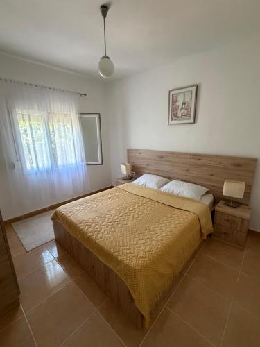 a bedroom with a large bed and a window at Fortress Apartment in Bar