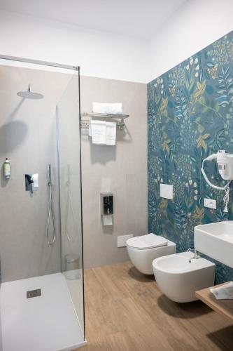 a bathroom with a shower and a toilet and a sink at B&B Melavì in Lizzano