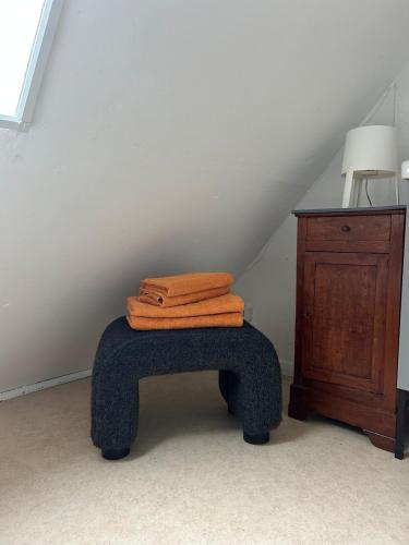 two towels sitting on top of a blue stool at Independent and comfortable room in Arrens-Marsous