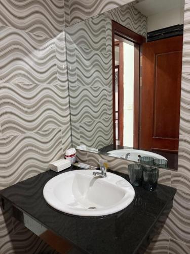 a bathroom with a sink and a tub at J&Q Hotel in Sihanoukville