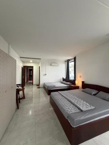a bedroom with two beds and a table in it at J&Q Hotel in Sihanoukville