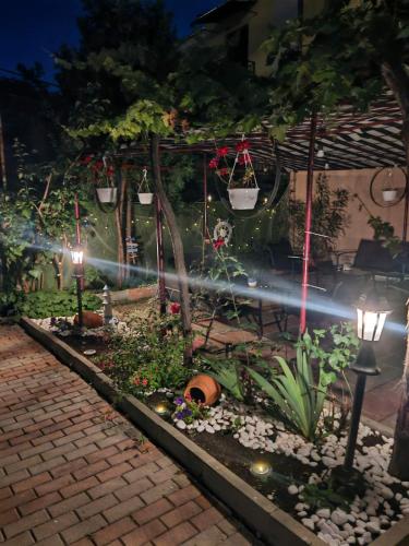a garden at night with lights and plants at Къща за гости Пиргос in Burgas