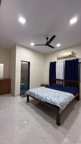 a bedroom with a bed and a ceiling fan at Hotel calm resort in Murud
