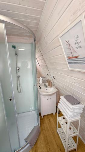 a bathroom with a shower and a sink at Nowa Siesta Camp Łeba in Nowęcin