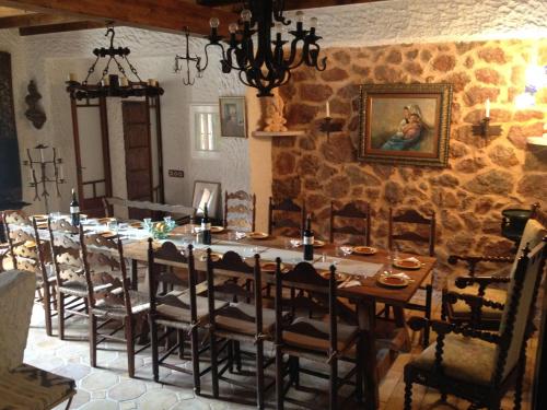 a dining room with a long table and chairs at Finca Ses Fontanelles in Andratx
