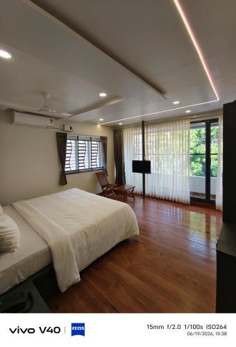 a bedroom with a large bed in a room at Velmora Luxe Residences in Madurai