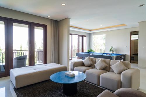 a living room with a couch and a pool table at Breeze Blows City View Villa 4 Bedrooms and 1 Familly Bedroom With a Private Heated Swimming Pool and a Billiard Table in Bandung