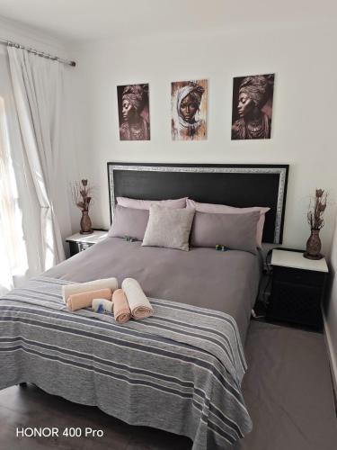 a bedroom with a large bed with two towels on it at Somerset west Stay 1 in Somerset West