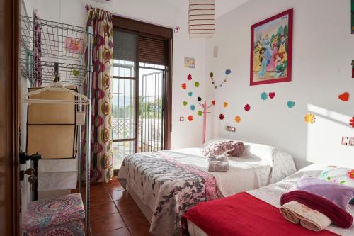 a bedroom with two beds and a window at La Majailla in Peal de Becerro
