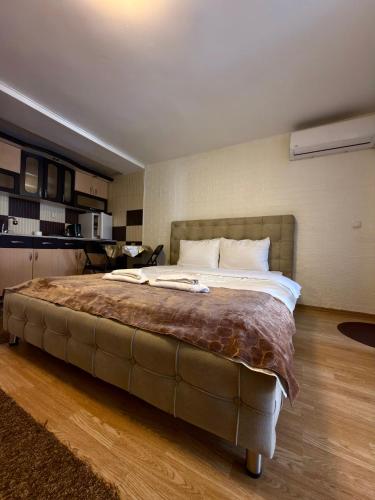 a bedroom with a large bed in a room at APARTMENT Marash in Prizren