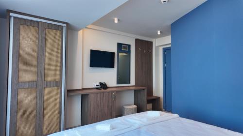 a hotel room with a bed and a mirror at Black Sea Resort in Eforie Sud
