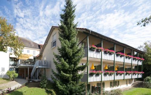 a large building with flowers on the balconies at Aparthotel Alter Weißbräu in Bad Birnbach