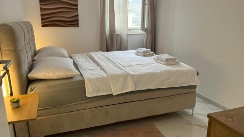 a bed with towels on it in a bedroom at Apartman Anela in Ivanica
