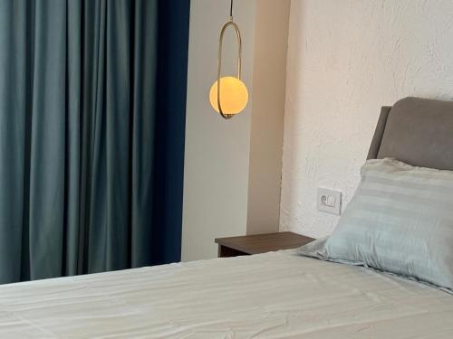 a bedroom with a bed with a blue curtain at Black Sea Resort in Eforie Sud