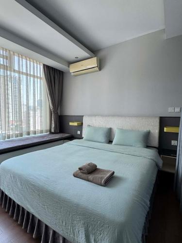 a bedroom with a bed with a towel on it at Modern and quiet Condo BKK1 - Rooftop Pool in Phnom Penh