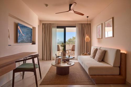 a living room with a couch and a table at Purobeach Resort Santa Ponsa in Santa Ponsa