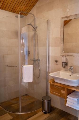 a bathroom with a shower and a sink at Fjalladýrð Hotel in Modrudalur