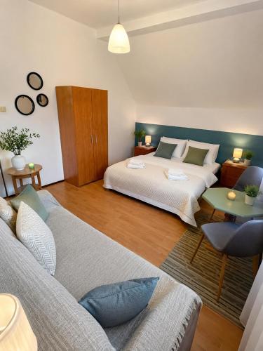 a bedroom with a bed and a couch in a room at Agroturystyka Anna in Dąbki