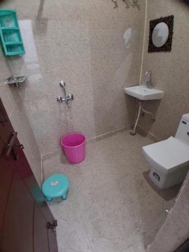 a bathroom with a toilet and a sink at Guruji Homestay Near UPES Collage in Jhājra