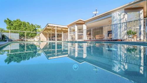a swimming pool in front of a building at Salt n Sand Beach house - 10min walk to Ocean - Idyllic coastal village in Ocean Shores