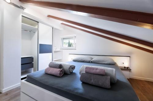 a bedroom with a bed with two pillows on it at Apartments Victoria in Dramalj
