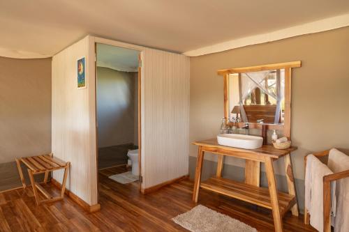 a bathroom with a sink and a toilet at Manya Luxury Camp in Serengeti