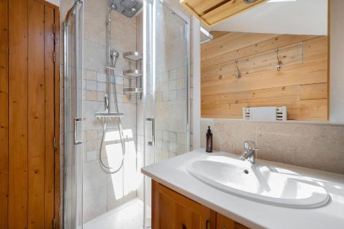 a bathroom with a sink and a shower at Chalet Le Hameau Tranquille in Courchevel