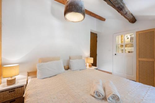 a bedroom with a large bed with two towels on it at Chalet Le Hameau Tranquille in Courchevel