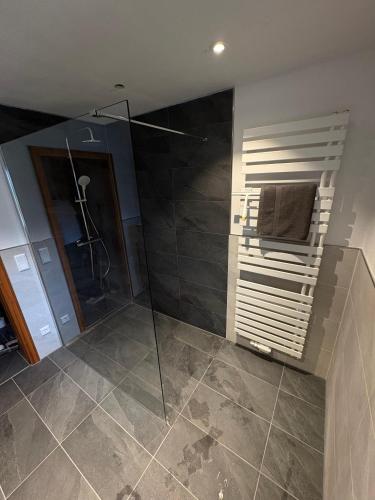 a bathroom with a shower and a glass shower stall at Chalet Lilly inkl. Chiemgaukarte in Ruhpolding