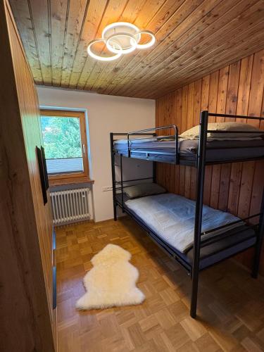 two bunk beds in a room with a ceiling at Chalet Lilly inkl. Chiemgaukarte in Ruhpolding