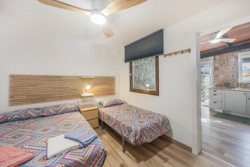 a bedroom with two beds and a window at Sunwaves 2 - Casa Oasis in El Palmar