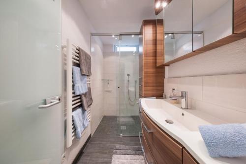 a bathroom with a tub and a sink and a shower at Stubai Apartment Telfes in Telfes im Stubai