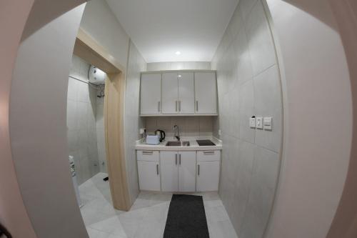 a small bathroom with a sink and a mirror at The view apartment -studio 1 in Al Baha