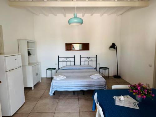 a bedroom with a bed and two tables in it at Appartamenti Alba&Tramonto in Stromboli